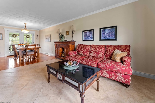 living room featuring light tile patterned floors and crown molding