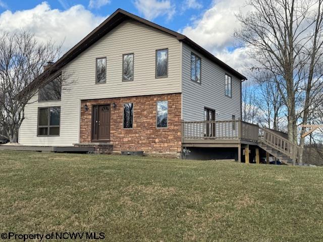 back of house featuring a yard and a wooden deck