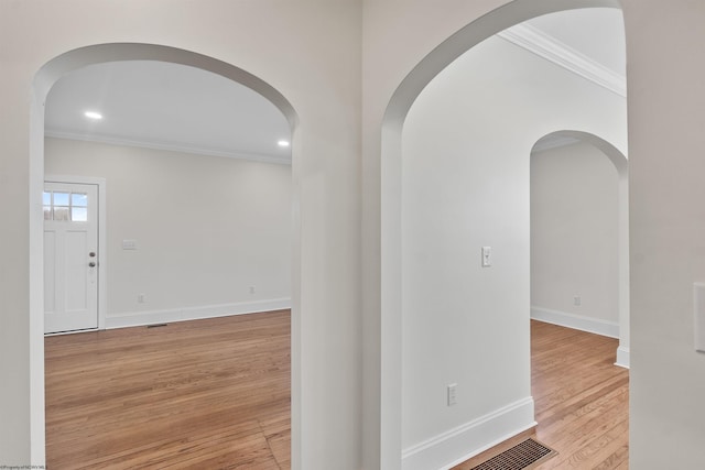 hall featuring crown molding and light wood-type flooring