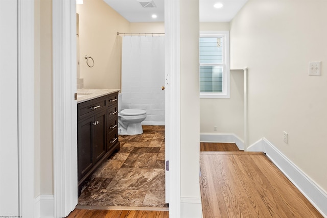 bathroom featuring vanity and toilet