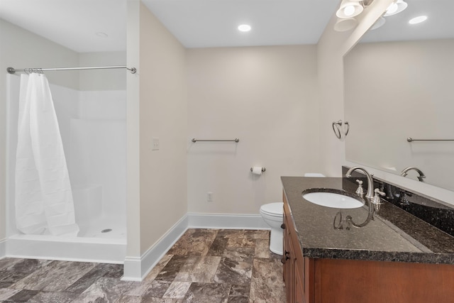 bathroom with vanity, toilet, and walk in shower