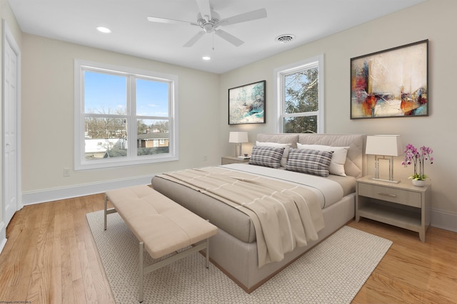 bedroom with ceiling fan and light hardwood / wood-style floors