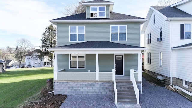 view of front of house with a front yard and covered porch