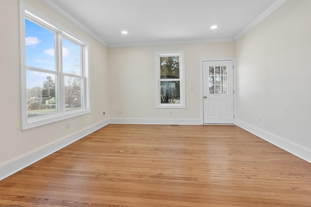 empty room featuring light hardwood / wood-style floors and crown molding