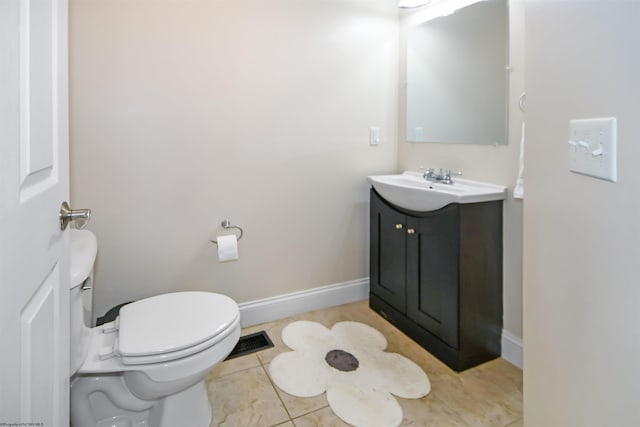 bathroom featuring tile patterned flooring, vanity, and toilet