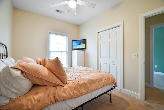 bedroom with ceiling fan, a closet, and carpet floors