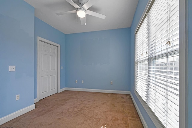 spare room featuring carpet flooring, plenty of natural light, and ceiling fan