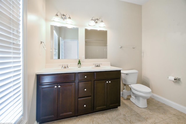 bathroom featuring tile patterned floors, vanity, and toilet