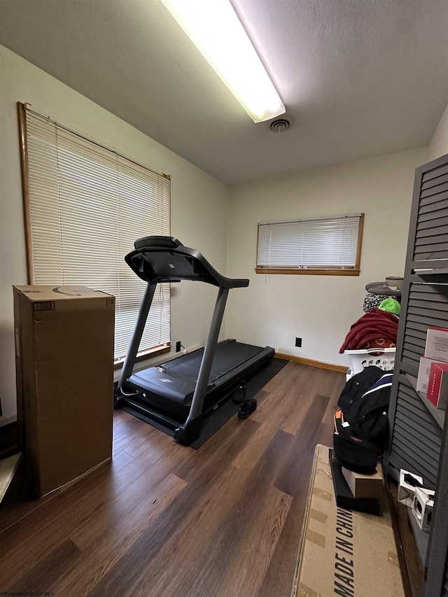 workout area with dark hardwood / wood-style flooring