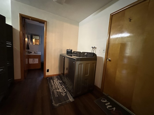 laundry room with washing machine and clothes dryer and dark hardwood / wood-style flooring