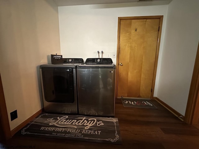 laundry area with dark hardwood / wood-style floors and independent washer and dryer