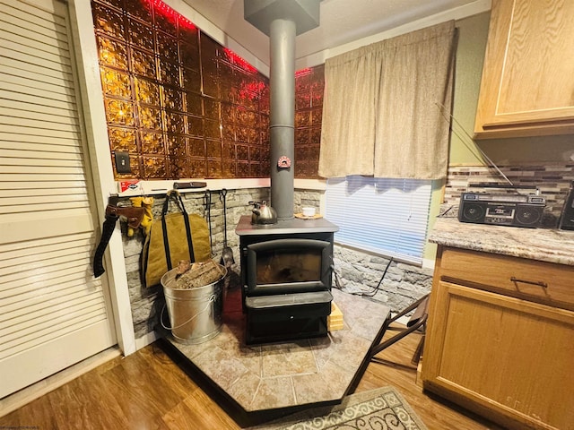 details with hardwood / wood-style flooring and a wood stove