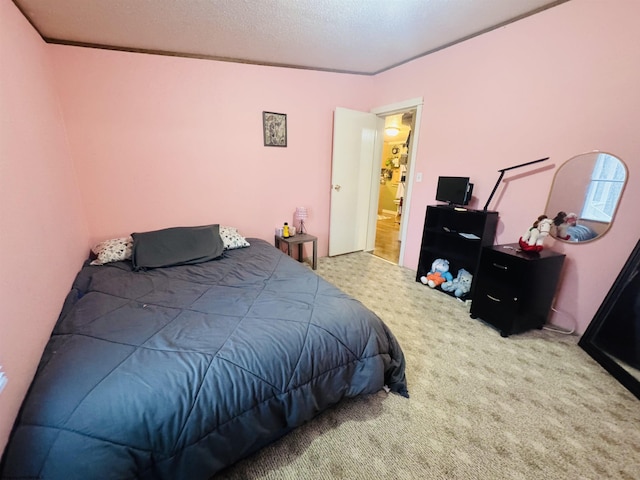 bedroom featuring carpet flooring, a textured ceiling, and crown molding