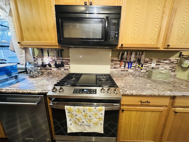 kitchen with light stone countertops and stainless steel gas range