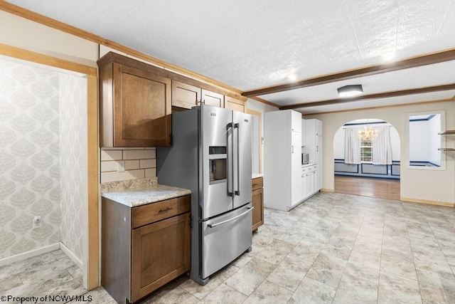 kitchen with backsplash and stainless steel fridge with ice dispenser