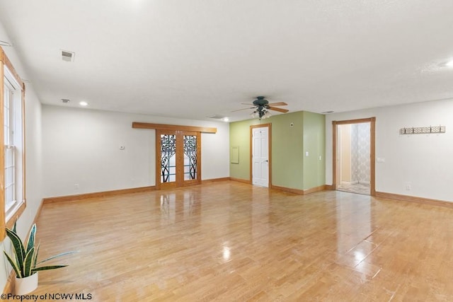 spare room featuring ceiling fan, french doors, and light hardwood / wood-style flooring