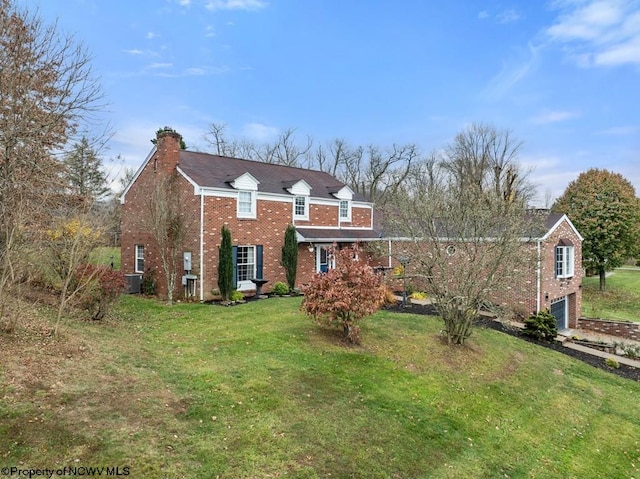 view of front of house featuring a garage, a front lawn, and central air condition unit