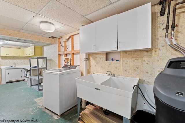 laundry room with washer and dryer, sink, and cabinets