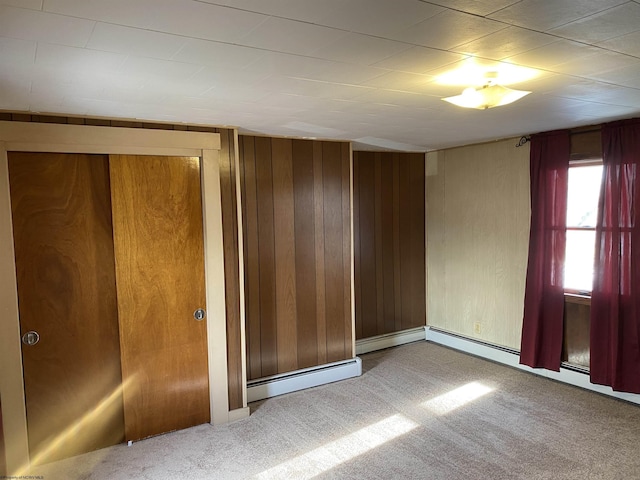 empty room with wooden walls and carpet floors