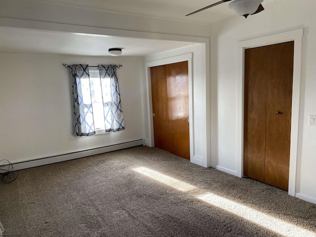 unfurnished bedroom with carpet, baseboard heating, and ceiling fan