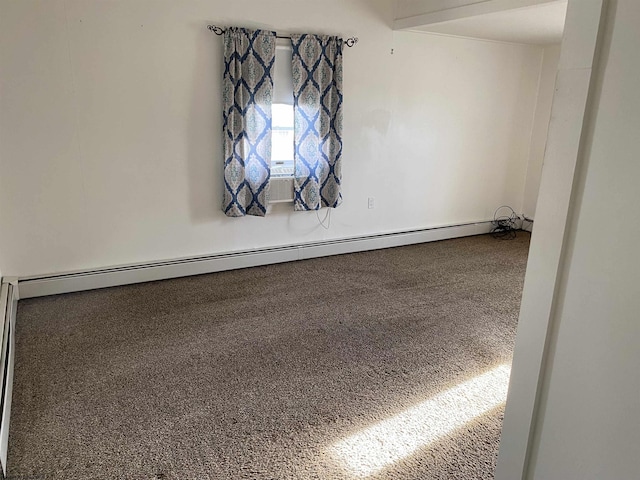 carpeted spare room featuring baseboard heating