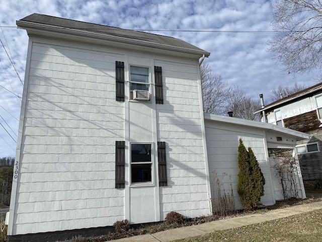 view of side of home featuring cooling unit