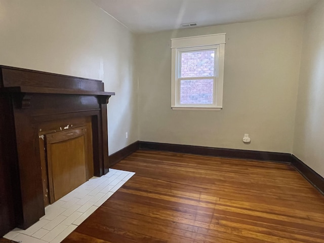 unfurnished living room featuring dark hardwood / wood-style flooring