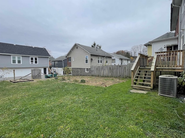 view of yard with cooling unit and a deck