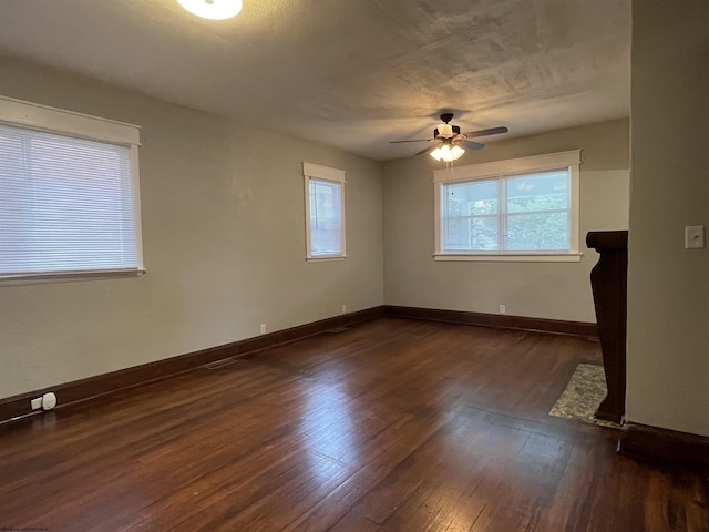 unfurnished room featuring ceiling fan and dark hardwood / wood-style floors