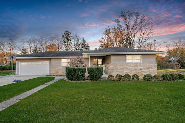 ranch-style home with a lawn and a garage