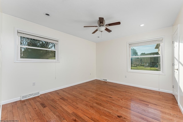 spare room with light hardwood / wood-style flooring and ceiling fan