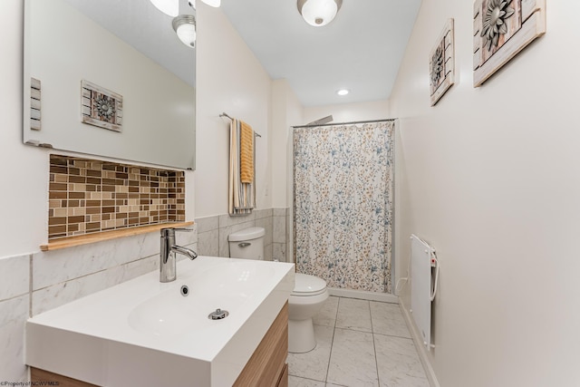 bathroom featuring vanity, toilet, and curtained shower