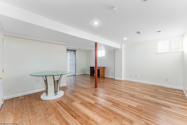 basement with light hardwood / wood-style floors