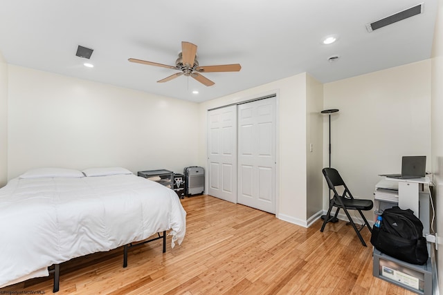 bedroom with light wood-type flooring, a closet, and ceiling fan