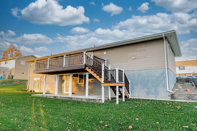 rear view of house with a yard, a patio, and a deck