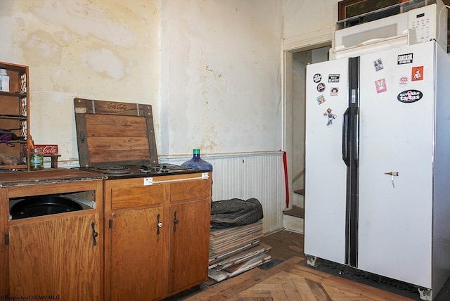 kitchen featuring dark parquet flooring and white fridge