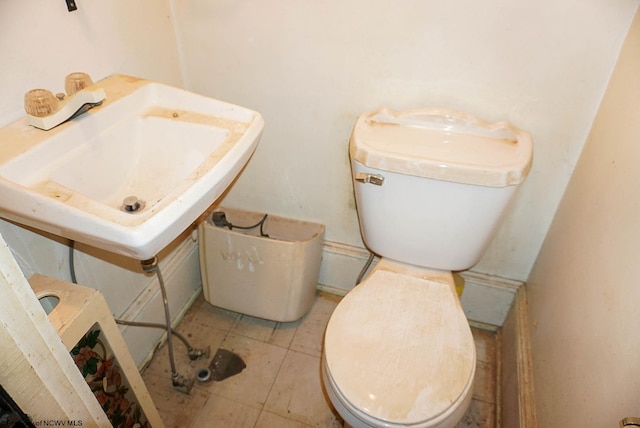 bathroom featuring tile patterned flooring, toilet, and sink