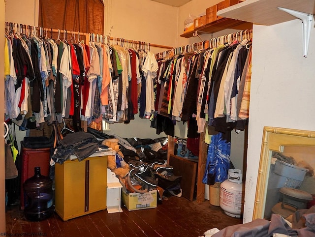 spacious closet featuring dark hardwood / wood-style flooring