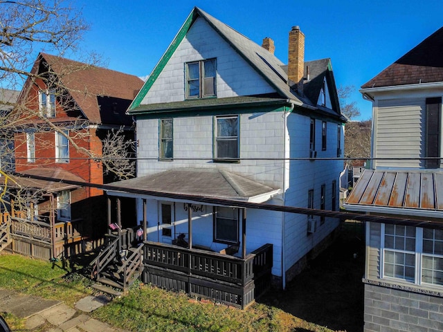 back of house featuring covered porch