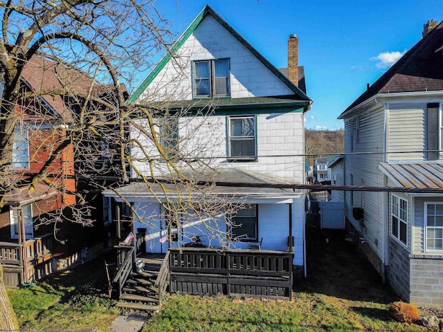 back of house with a wooden deck