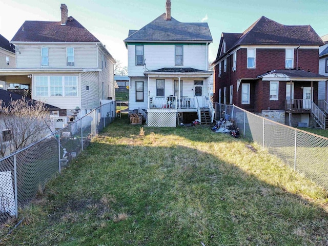 back of property with a lawn