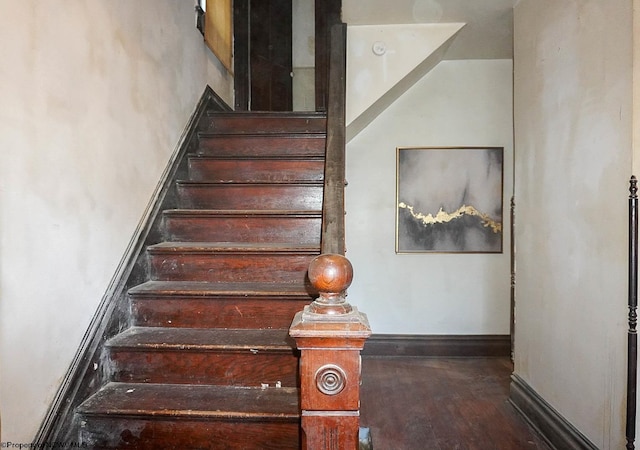 stairway featuring wood-type flooring