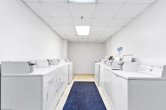 laundry room featuring light wood-type flooring and washer and clothes dryer