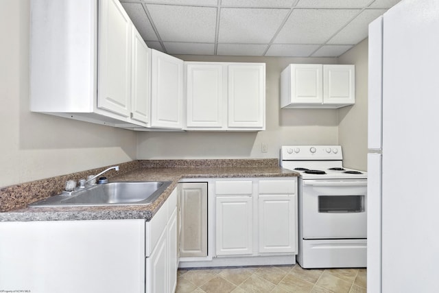 kitchen featuring a paneled ceiling, sink, white cabinets, and white appliances