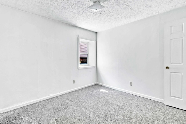 spare room with carpet flooring and a textured ceiling