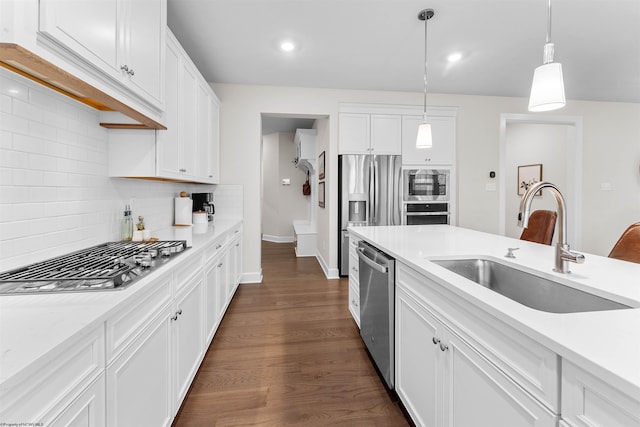 kitchen featuring backsplash, white cabinetry, sink, and stainless steel appliances