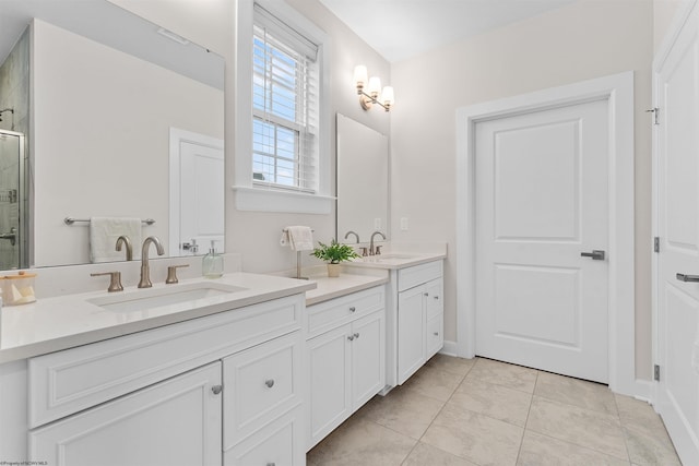 bathroom with vanity, tile patterned floors, and a shower with door