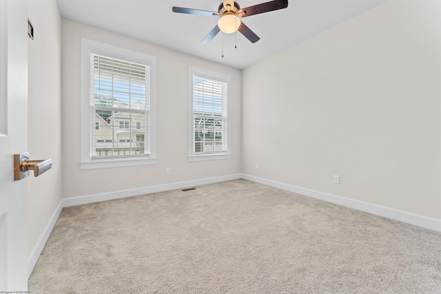 unfurnished room featuring light carpet and ceiling fan