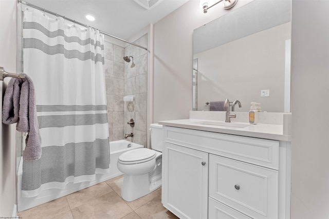 full bathroom featuring tile patterned floors, shower / tub combo with curtain, vanity, and toilet