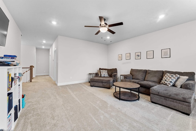 carpeted living room featuring ceiling fan